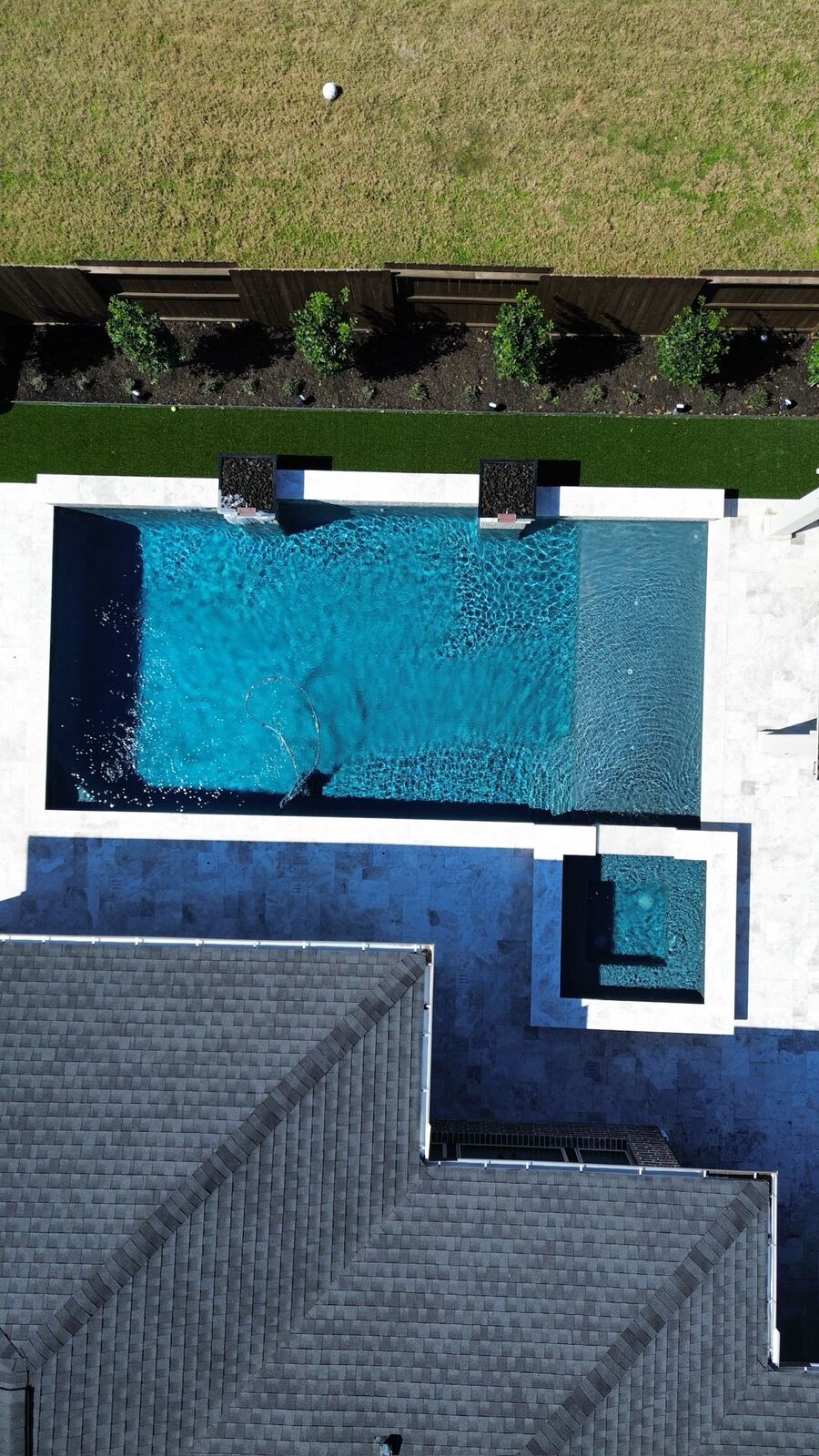 Vertical aerial view of a modern rectangular pool and spa