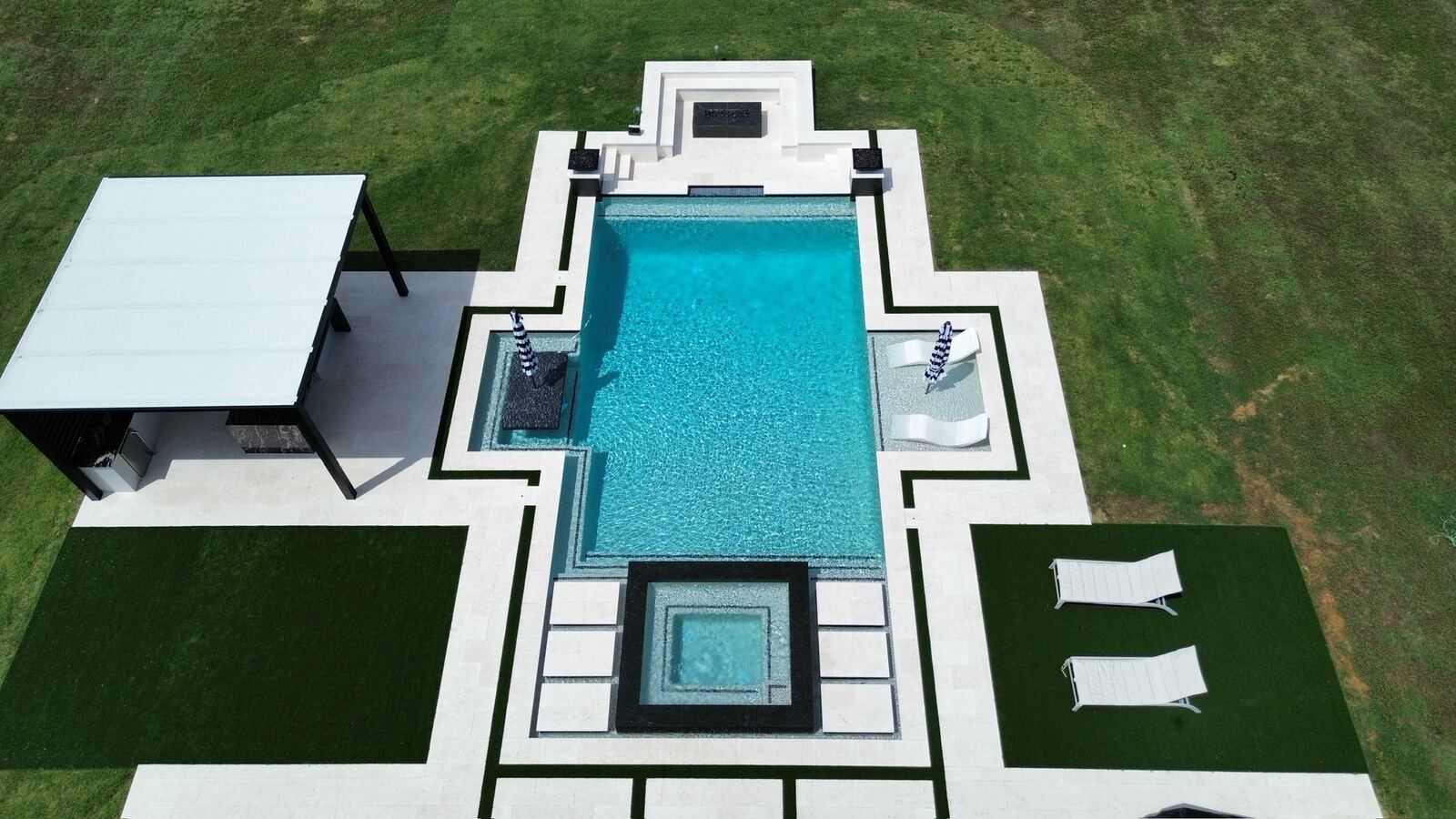 Aerial view of a modern geometric pool with fire features