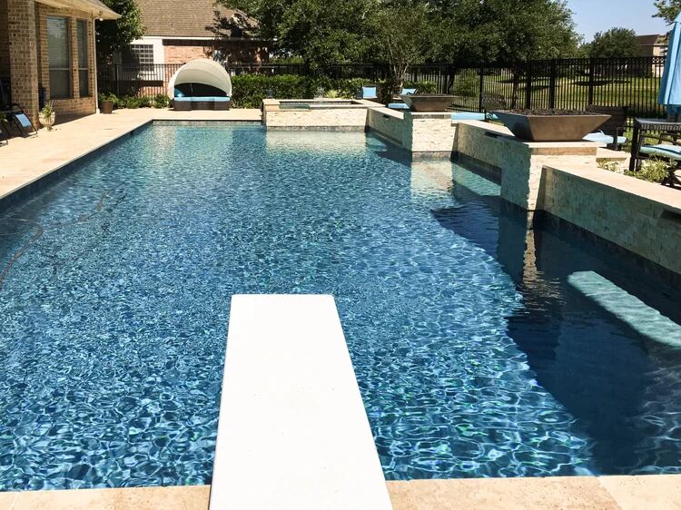Pool with diving board, shade cabana and raised spa