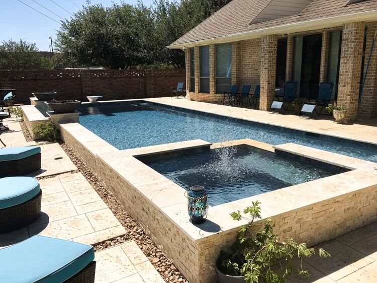 Pool with raised spa fountain and travertine patio