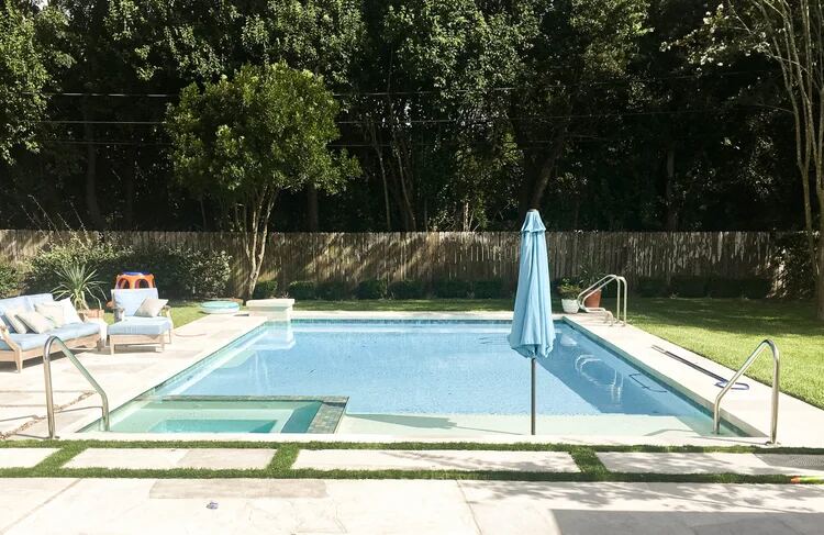 Rectangular pool with umbrella, raised spa and lounge furniture
